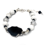 Close-up of white howlite faceted beads, black Czech glass beads, and silver-plated spacers in "Lake Moon" bracelet from STARSNOW Collection