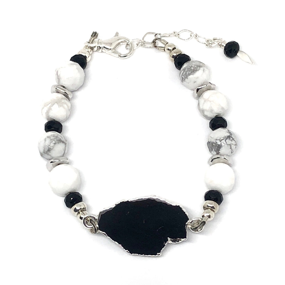 Black, white, gray, and silver "Lake Moon" bracelet from STARSNOW Collection, featuring black tourmaline focal and white howlite beads, on a white background
